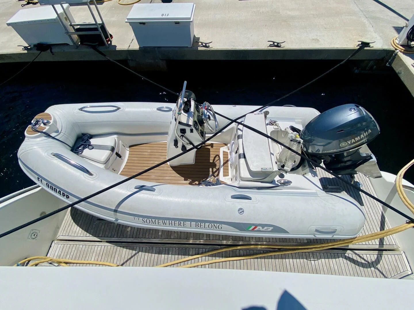 a boat with a motor attached to it aboard SOMEWHERE I BELONG Yacht for Sale