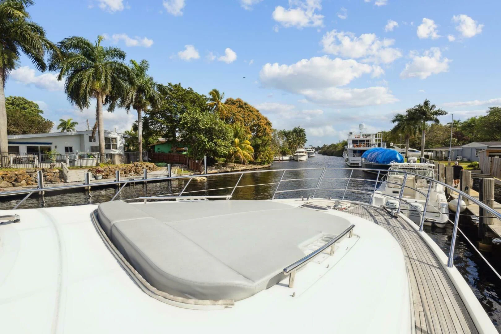 a large white boat on a body of water aboard SOMEWHERE I BELONG Yacht for Sale
