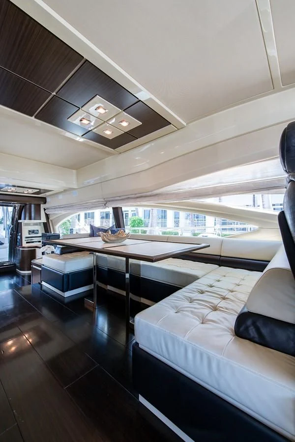 a room with a large table and a couch aboard SOMEWHERE I BELONG Yacht for Sale