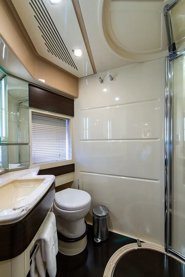 a bathroom with a toilet and sink aboard SOMEWHERE I BELONG Yacht for Sale
