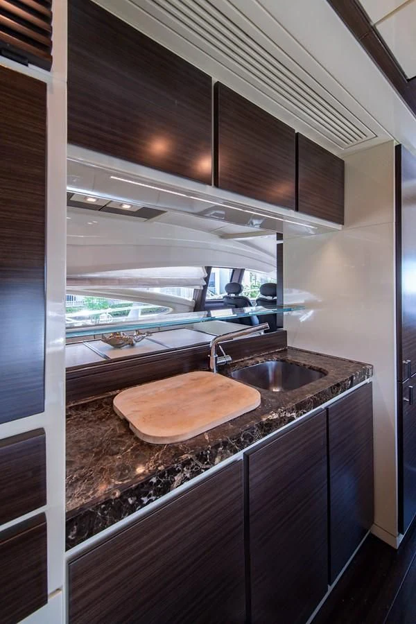 a kitchen with a sink and a large window aboard SOMEWHERE I BELONG Yacht for Sale