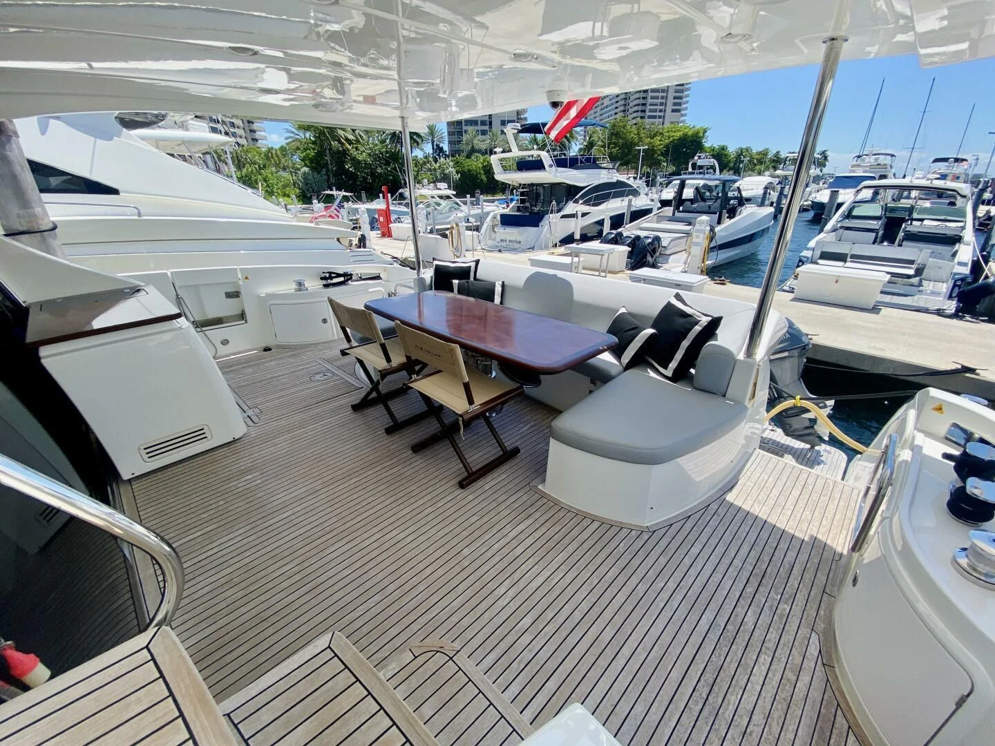 a room with a table chairs and a window with a view of the water aboard SOMEWHERE I BELONG Yacht for Sale