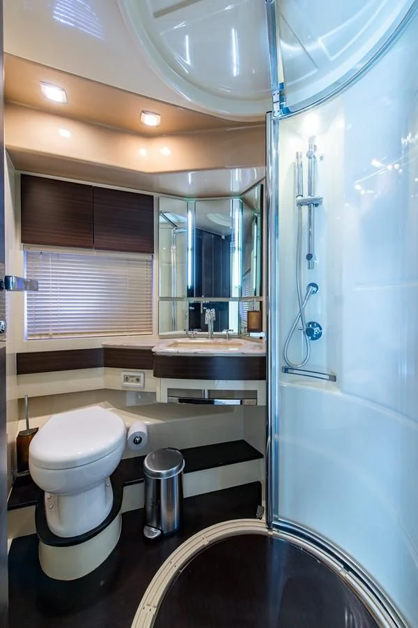 a bathroom with a glass shower aboard SOMEWHERE I BELONG Yacht for Sale
