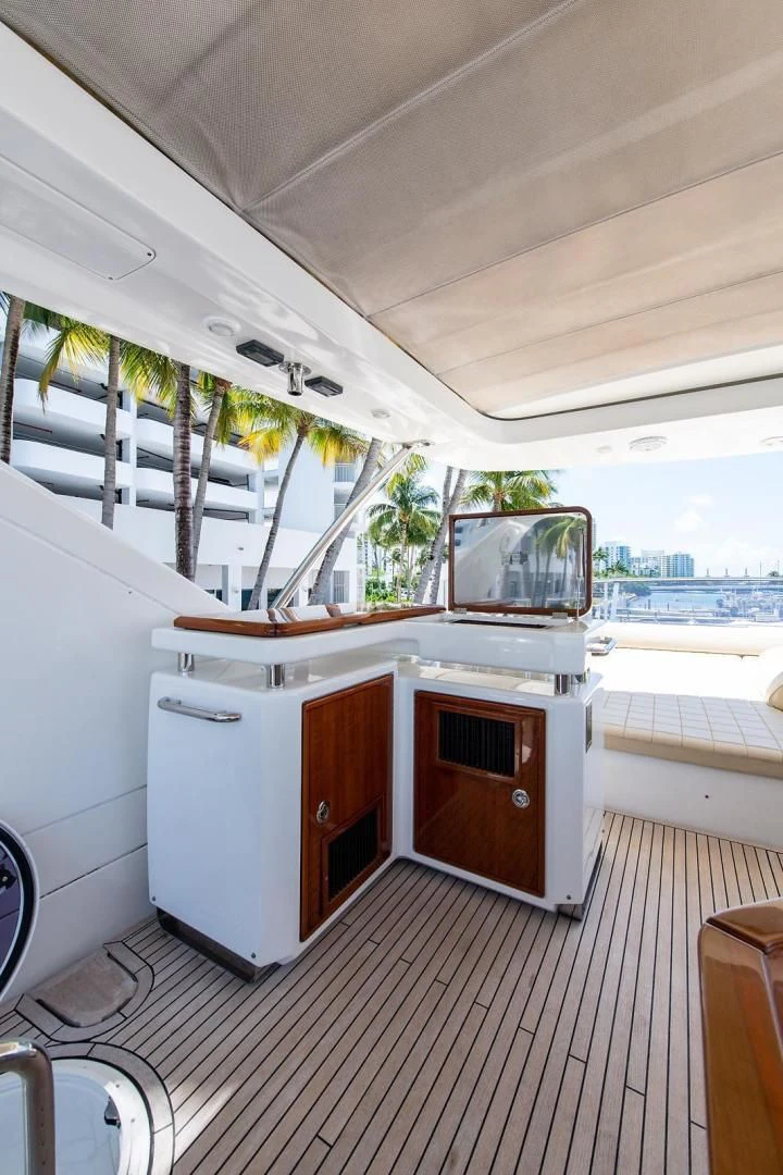 a room with a wood stove and cabinets and a wood table aboard SOMEWHERE I BELONG Yacht for Sale