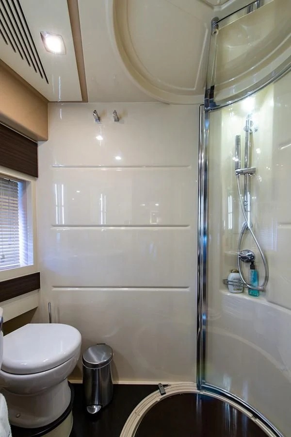 a bathroom with a glass shower aboard SOMEWHERE I BELONG Yacht for Sale