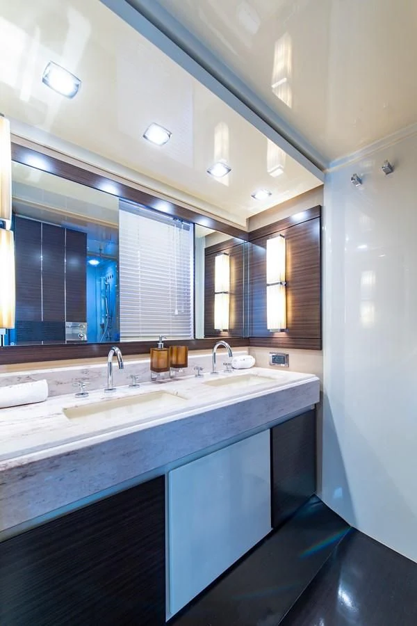 a bathroom with a large mirror aboard SOMEWHERE I BELONG Yacht for Sale