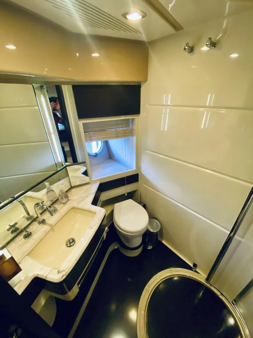 a bathroom with a large mirror aboard SOMEWHERE I BELONG Yacht for Sale
