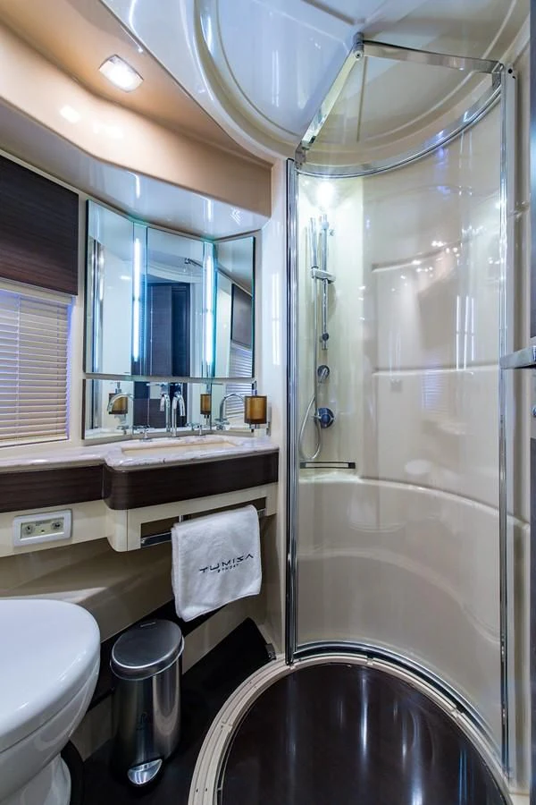 a bathroom with a glass shower aboard SOMEWHERE I BELONG Yacht for Sale