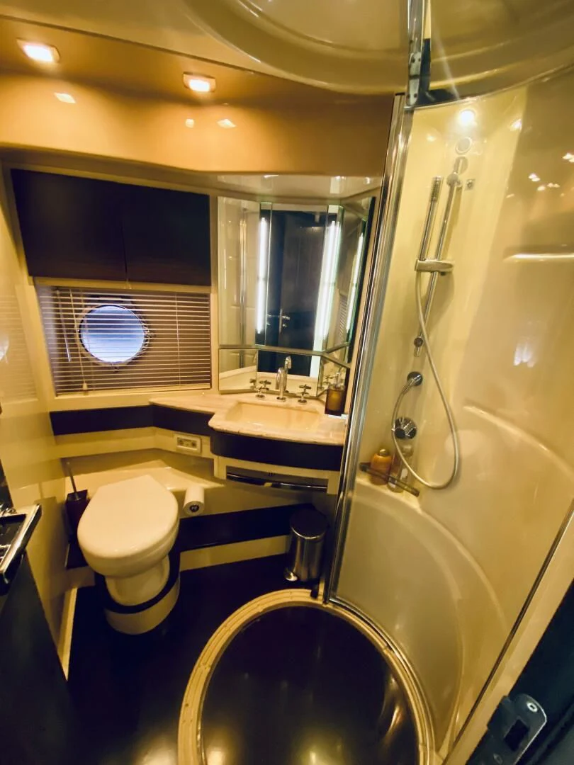 a bathroom with a tub sink and toilet aboard SOMEWHERE I BELONG Yacht for Sale
