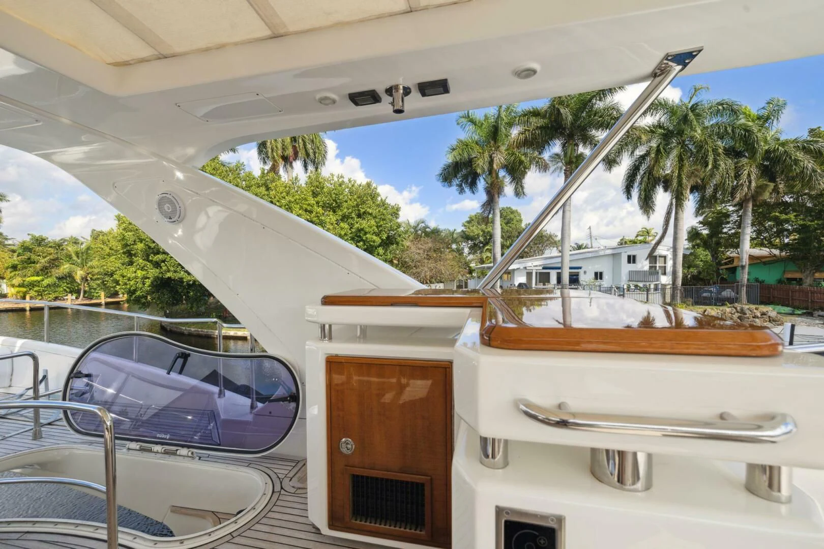 a white boat with a deck and trees in the background aboard SOMEWHERE I BELONG Yacht for Sale