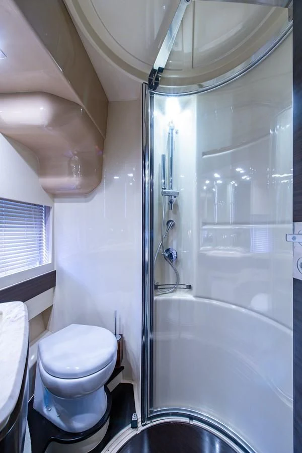 a bathroom with a glass shower aboard SOMEWHERE I BELONG Yacht for Sale