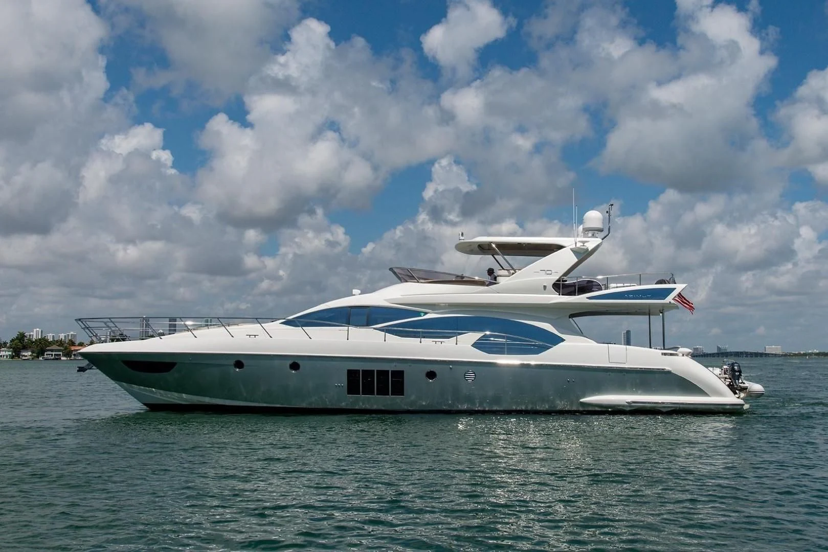 a white yacht on the water aboard SOMEWHERE I BELONG Yacht for Sale