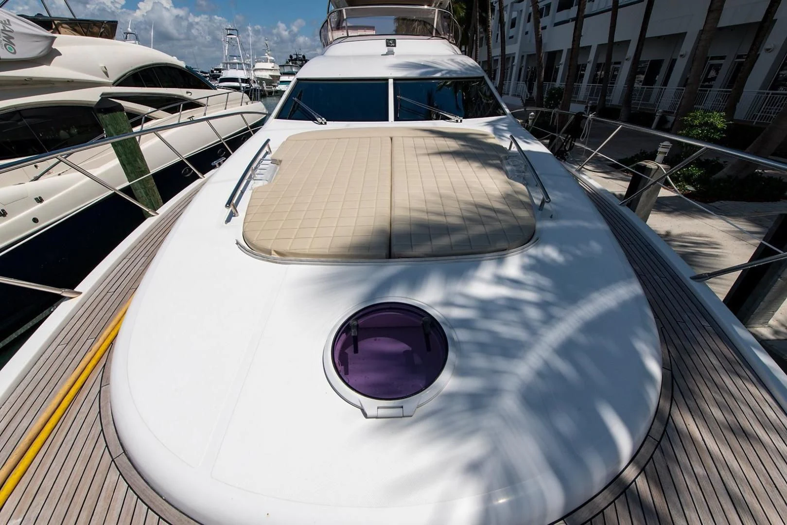 a white yacht on a dock aboard SOMEWHERE I BELONG Yacht for Sale
