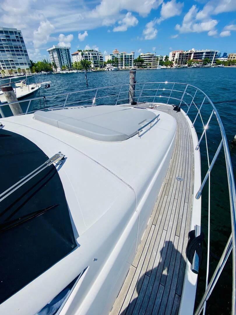 a large white boat in a harbor aboard SOMEWHERE I BELONG Yacht for Sale