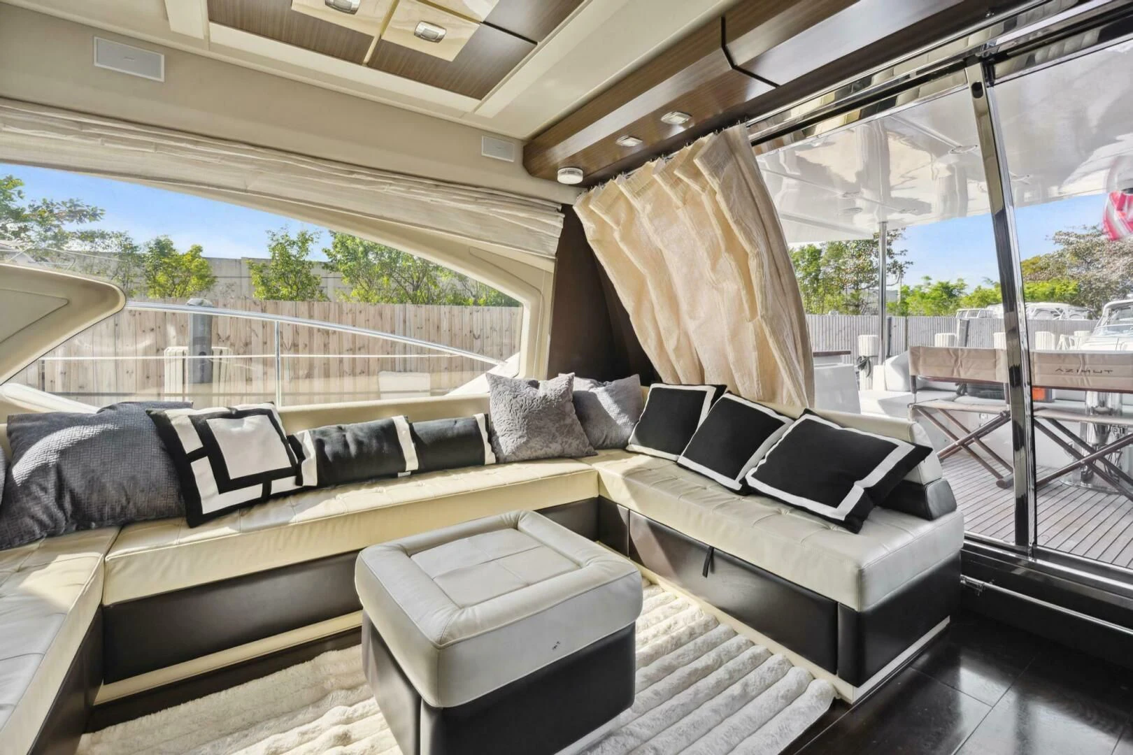 a couch and a table in a room with a view of the ocean aboard SOMEWHERE I BELONG Yacht for Sale
