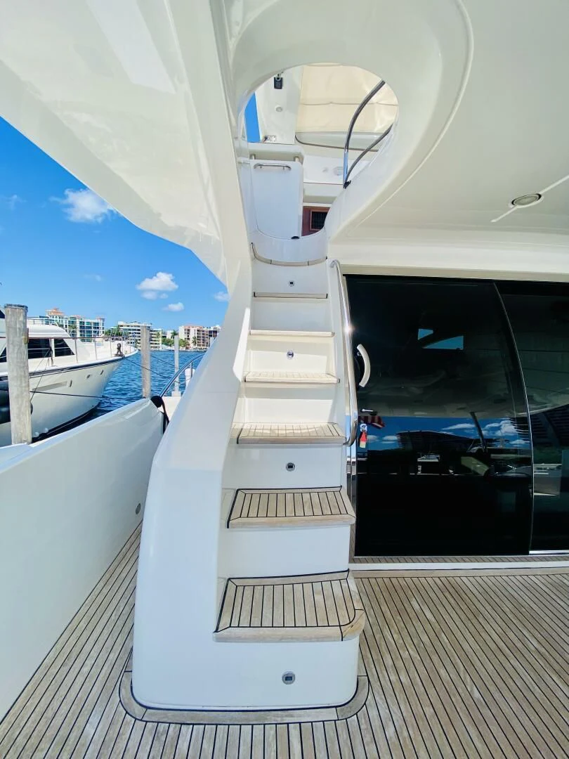 a white boat on a dock aboard SOMEWHERE I BELONG Yacht for Sale