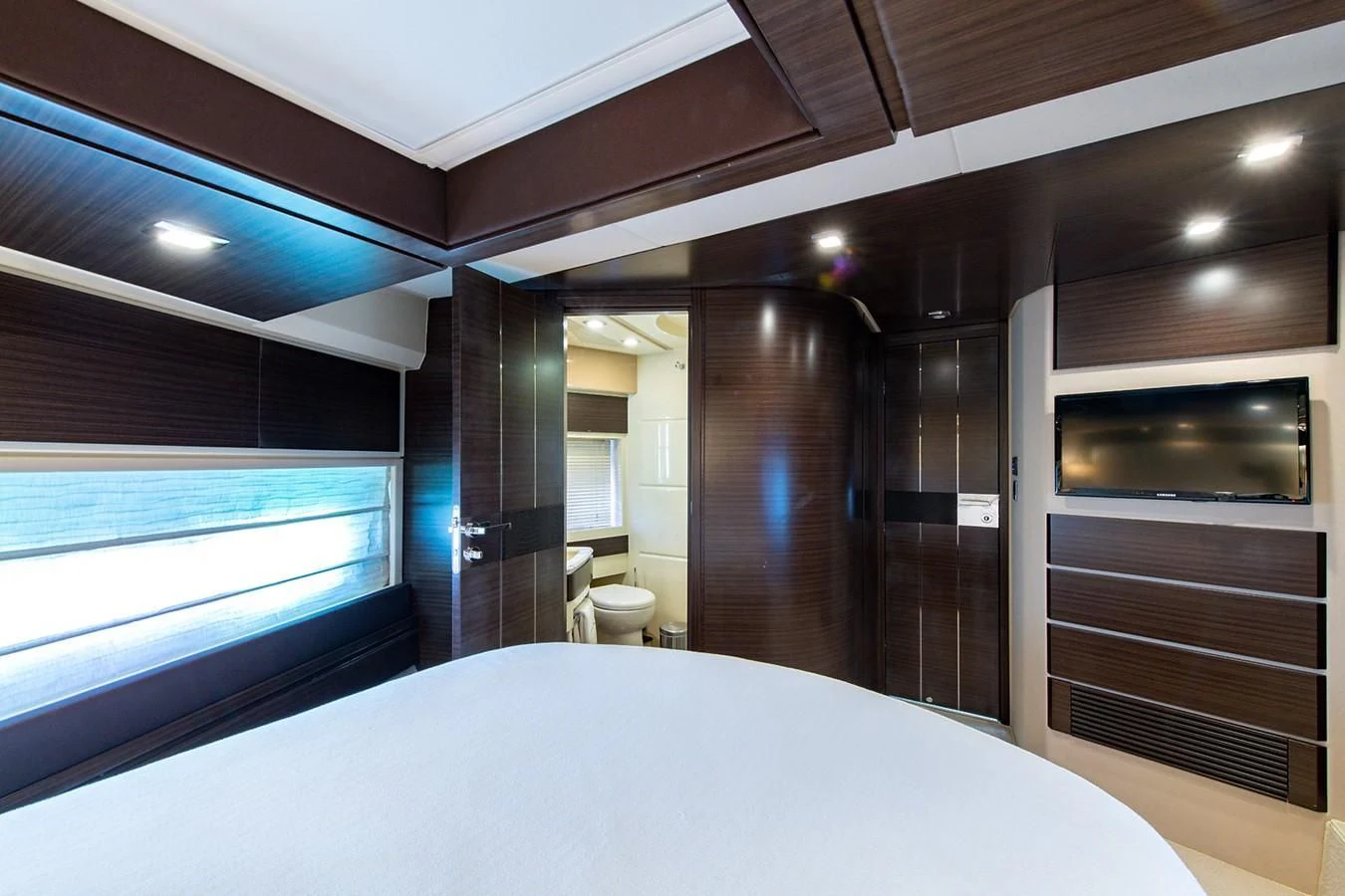 a large room with a large bed aboard SOMEWHERE I BELONG Yacht for Sale