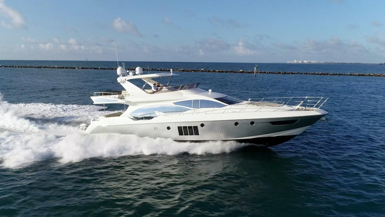 a white yacht in the water aboard SOMEWHERE I BELONG Yacht for Sale