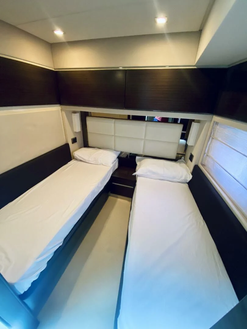 a room with several beds aboard SOMEWHERE I BELONG Yacht for Sale