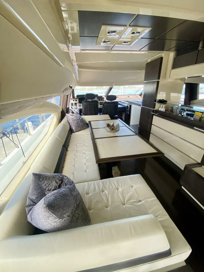 a room with a table and chairs aboard SOMEWHERE I BELONG Yacht for Sale