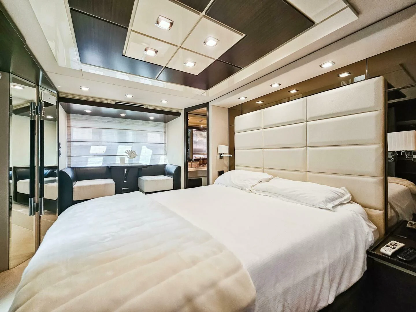 a room with a bed and a chair aboard SOMEWHERE I BELONG Yacht for Sale