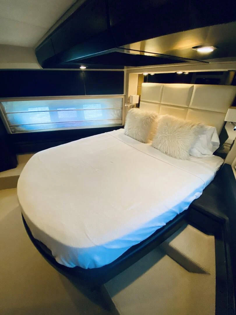 a bed with white sheets aboard SOMEWHERE I BELONG Yacht for Sale