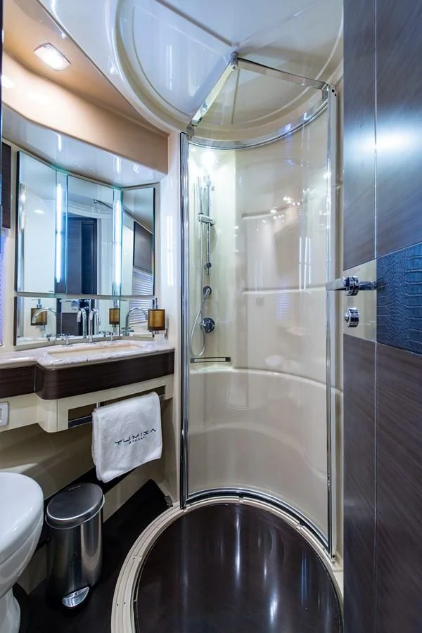 a bathroom with a glass shower aboard SOMEWHERE I BELONG Yacht for Sale