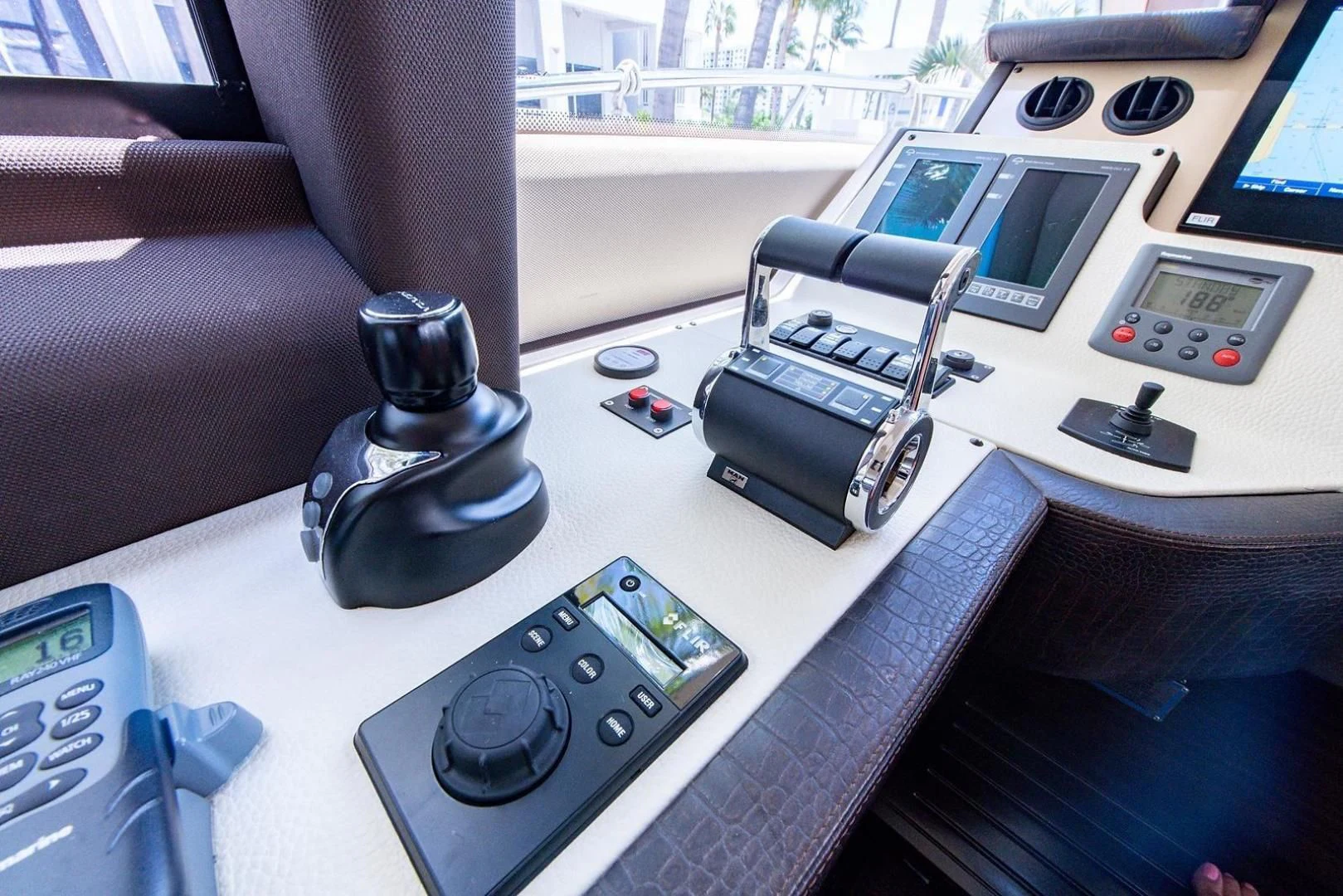 a table with a telephone and a couple of electronic devices on it aboard SOMEWHERE I BELONG Yacht for Sale