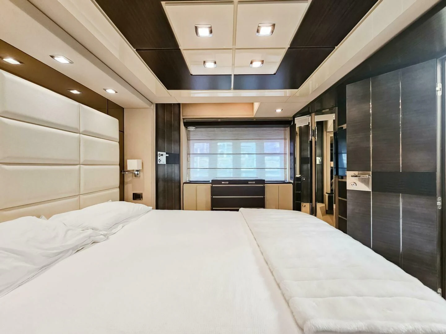 a large hotel room with a large bed aboard SOMEWHERE I BELONG Yacht for Sale