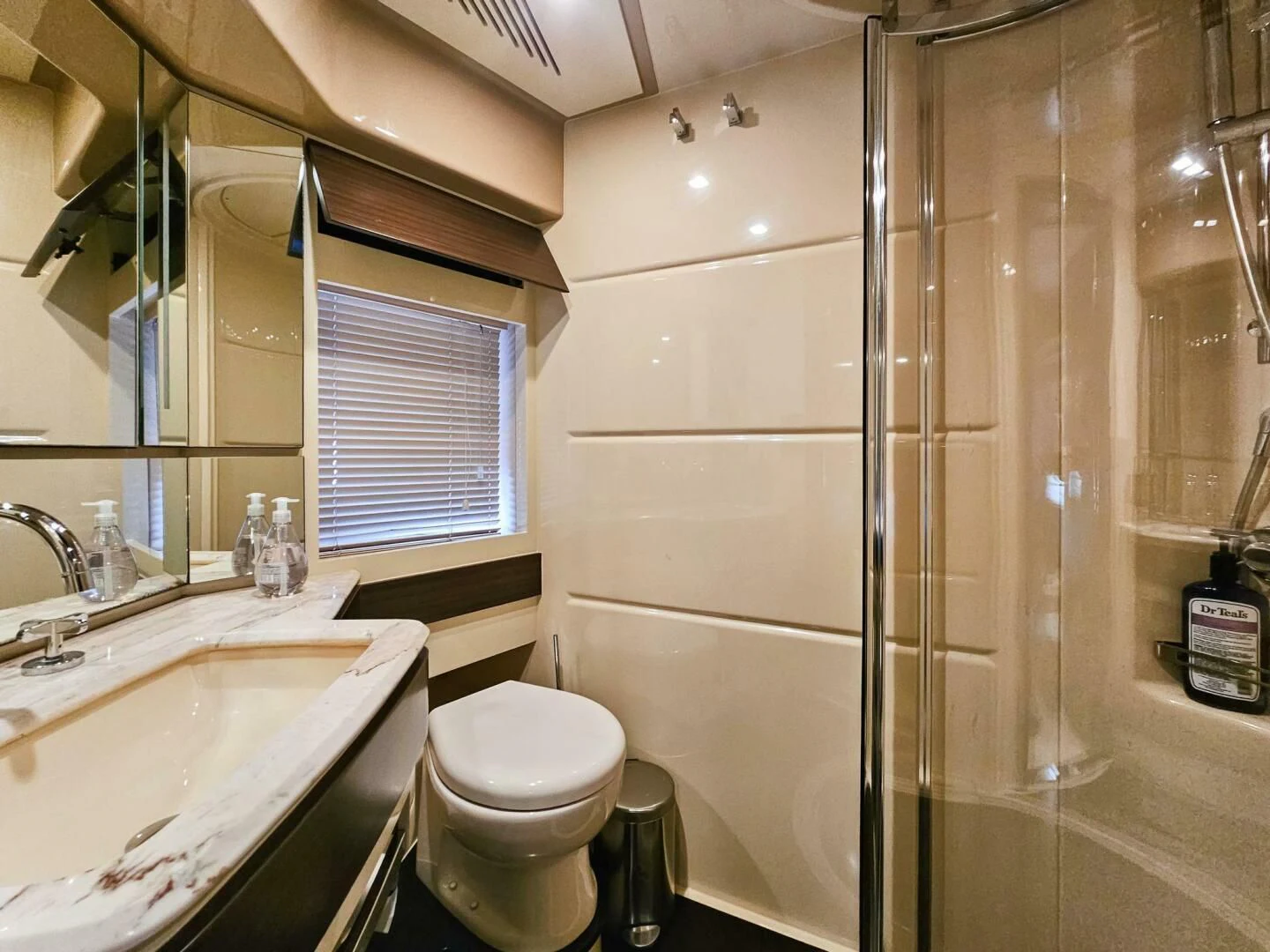 a bathroom with a glass shower aboard SOMEWHERE I BELONG Yacht for Sale