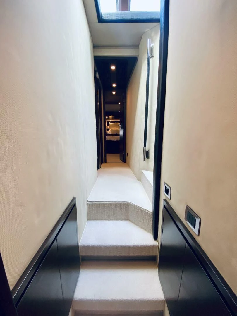 a hallway with a white carpet aboard SOMEWHERE I BELONG Yacht for Sale