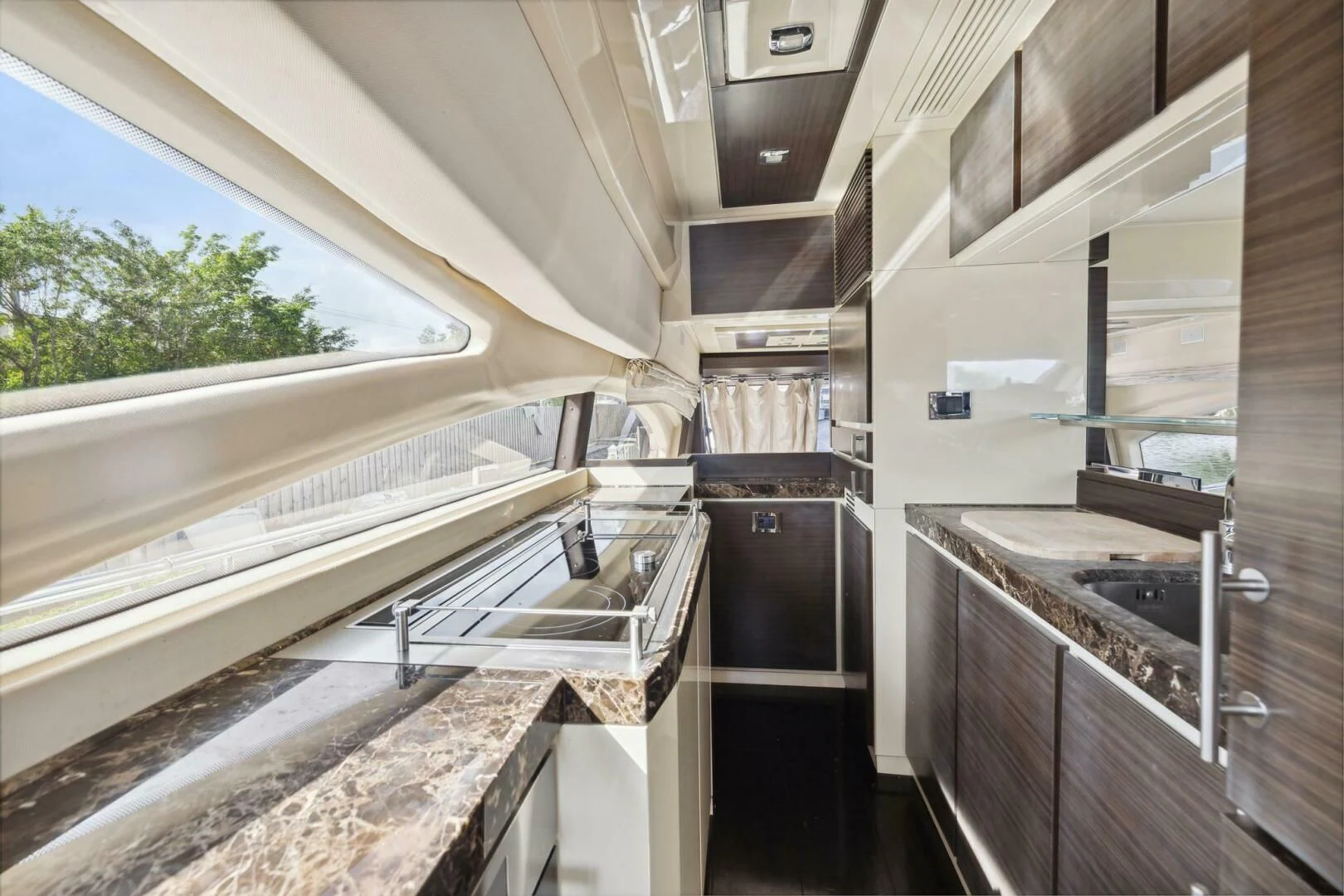 a kitchen with a large window aboard SOMEWHERE I BELONG Yacht for Sale