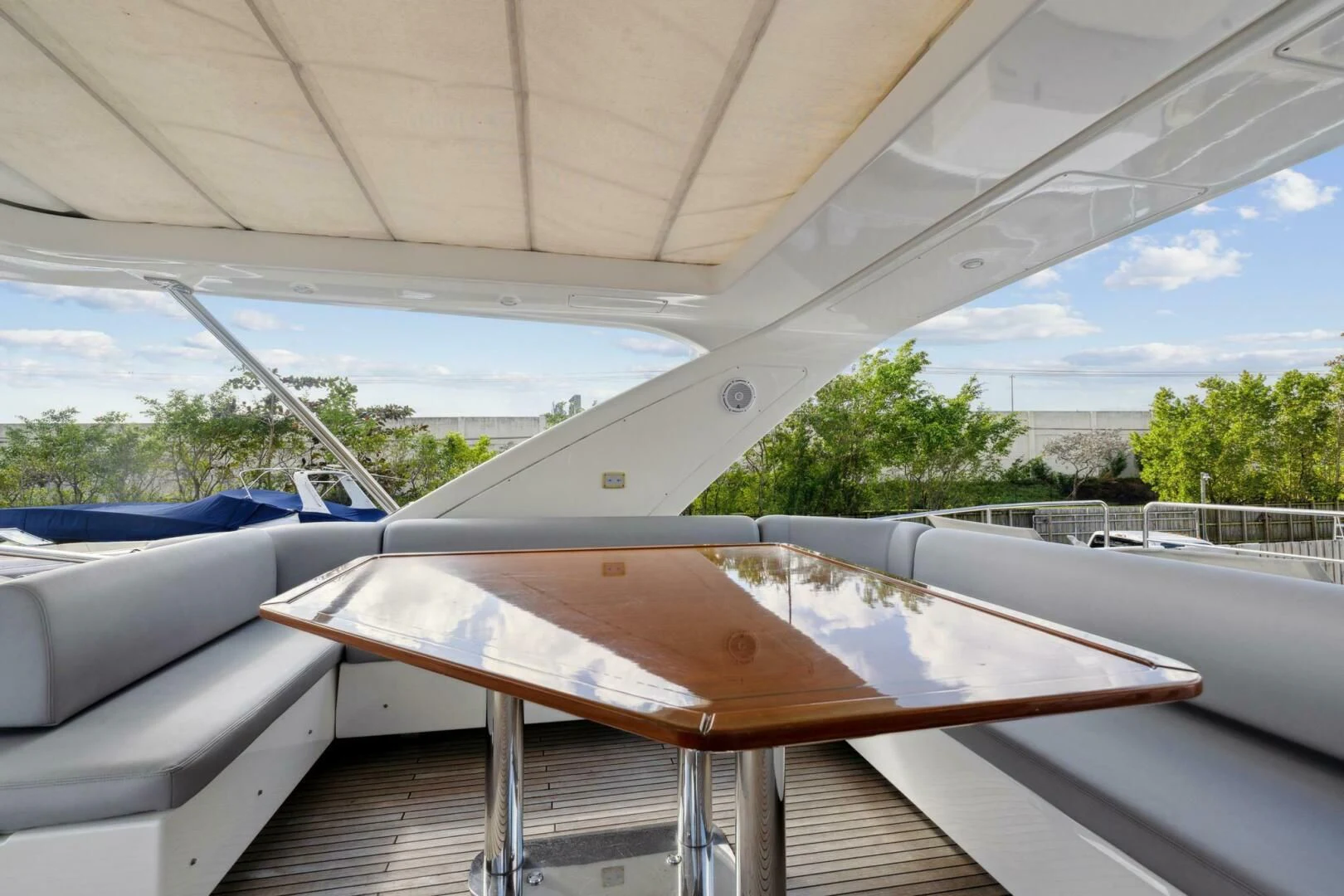 a deck with a table and chairs aboard SOMEWHERE I BELONG Yacht for Sale