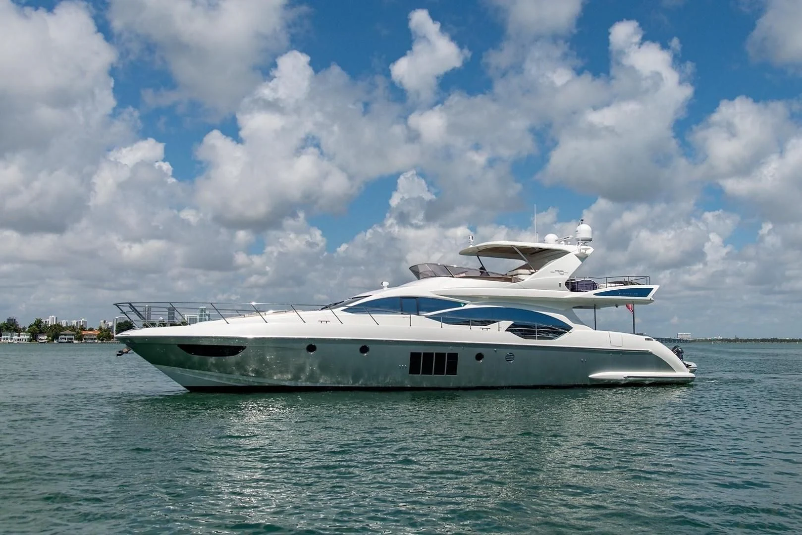 a white boat on the water aboard SOMEWHERE I BELONG Yacht for Sale