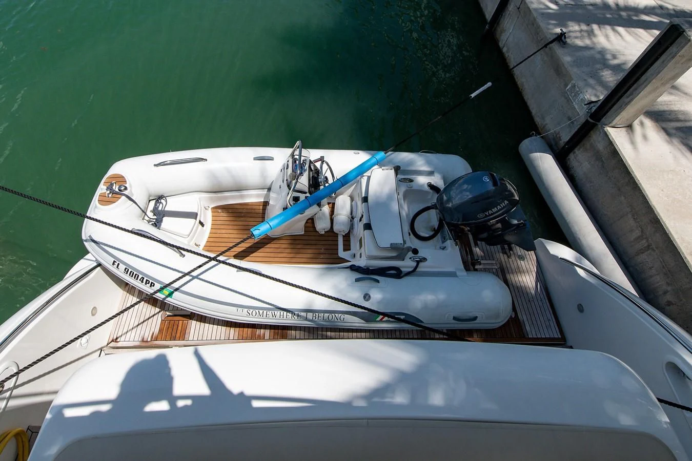 a white boat with a motor attached to it aboard SOMEWHERE I BELONG Yacht for Sale