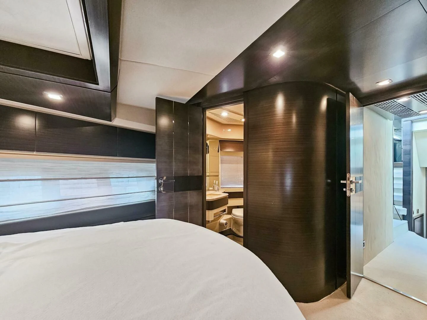 a bed next to a door aboard SOMEWHERE I BELONG Yacht for Sale