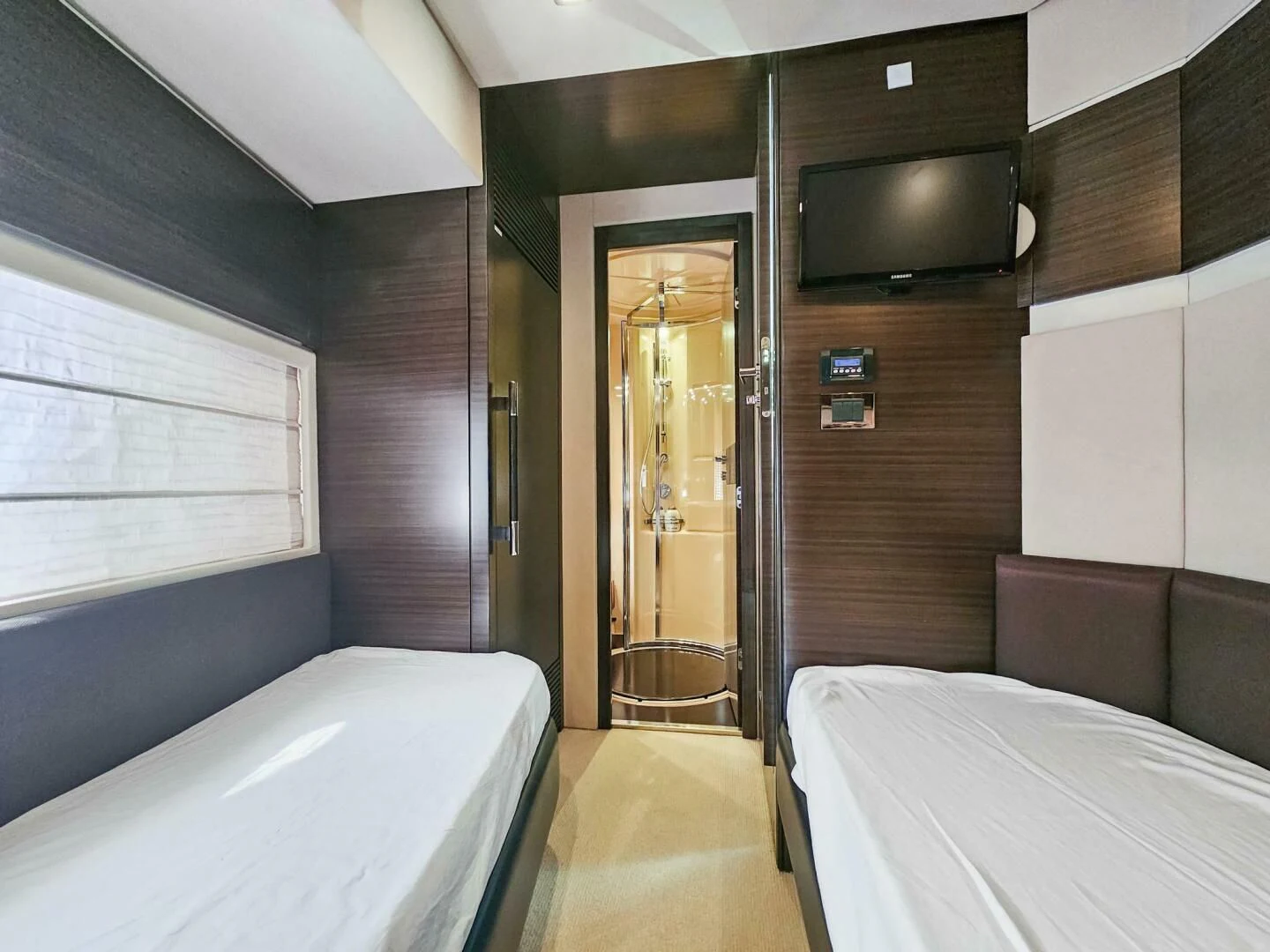 a room with a bed and a television aboard SOMEWHERE I BELONG Yacht for Sale