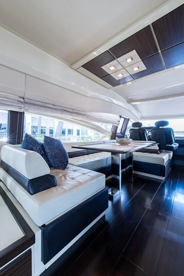 a room with a couch and a table aboard SOMEWHERE I BELONG Yacht for Sale