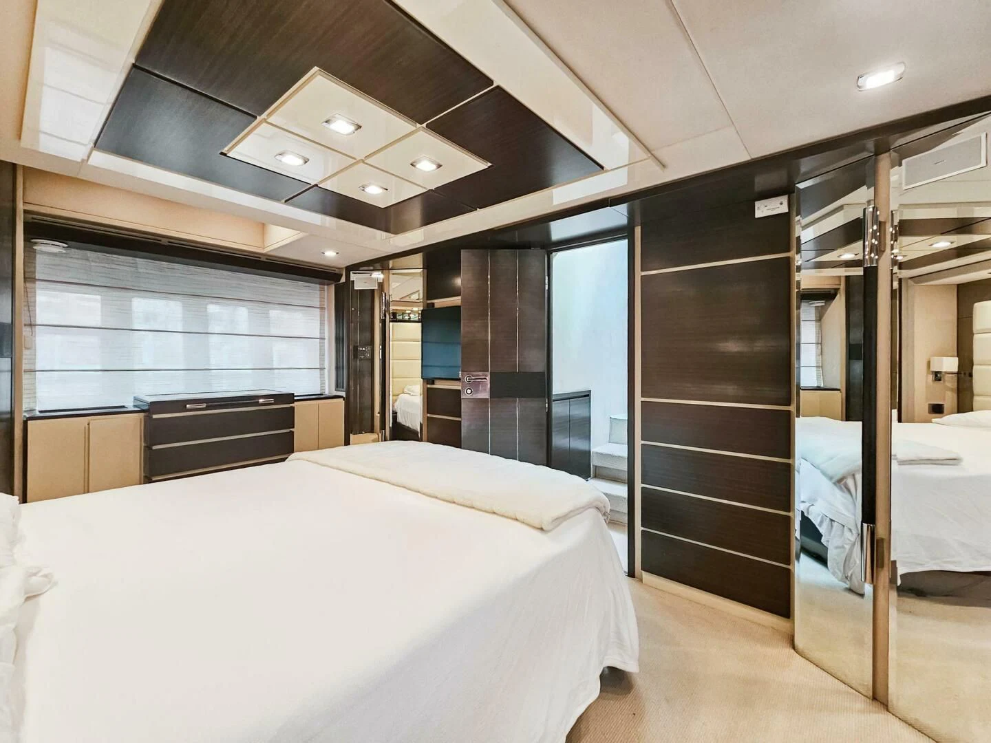 a room with a bed and a mirror aboard SOMEWHERE I BELONG Yacht for Sale