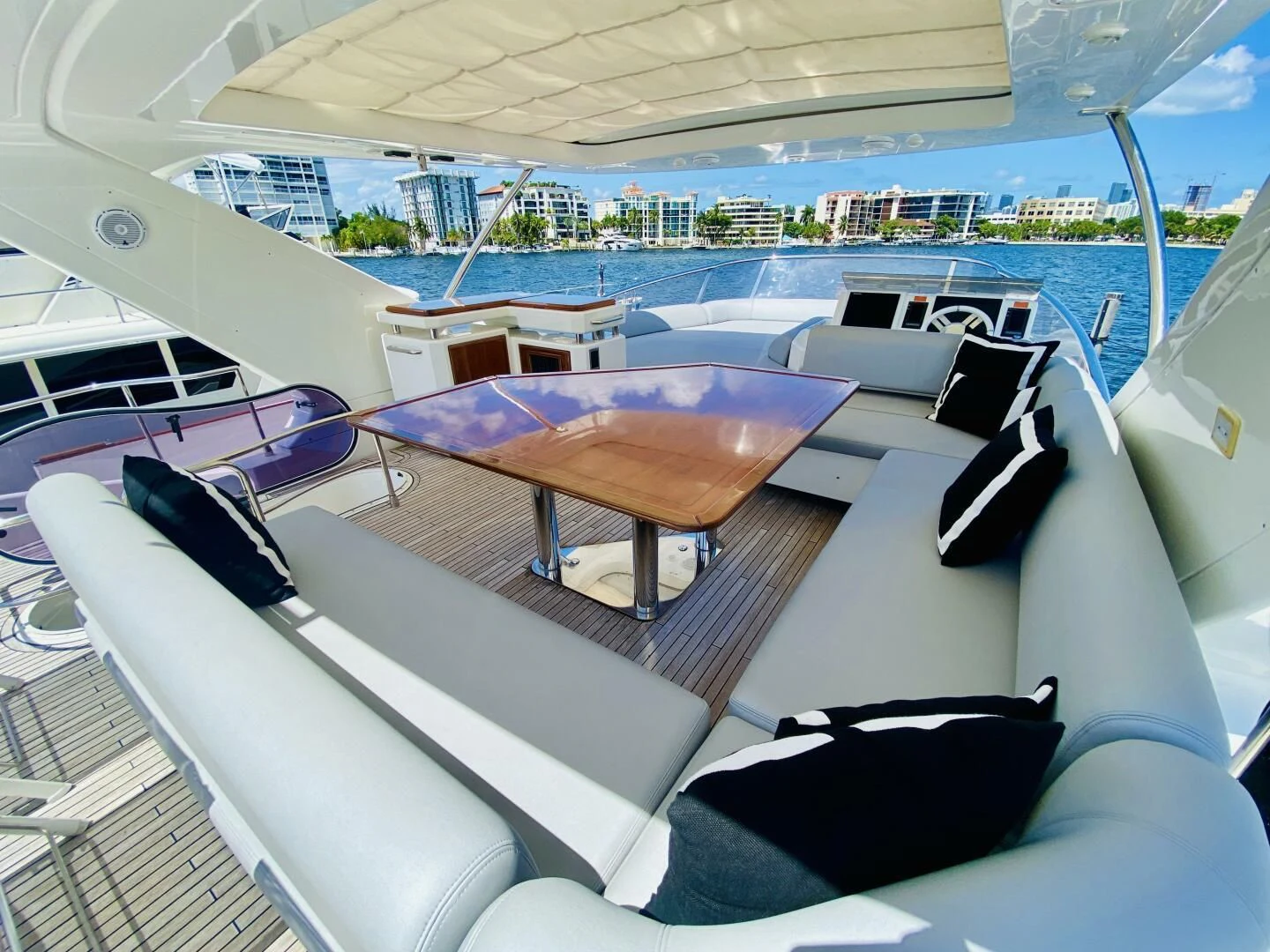 a deck with a pool and a deck with chairs and a large building aboard SOMEWHERE I BELONG Yacht for Sale