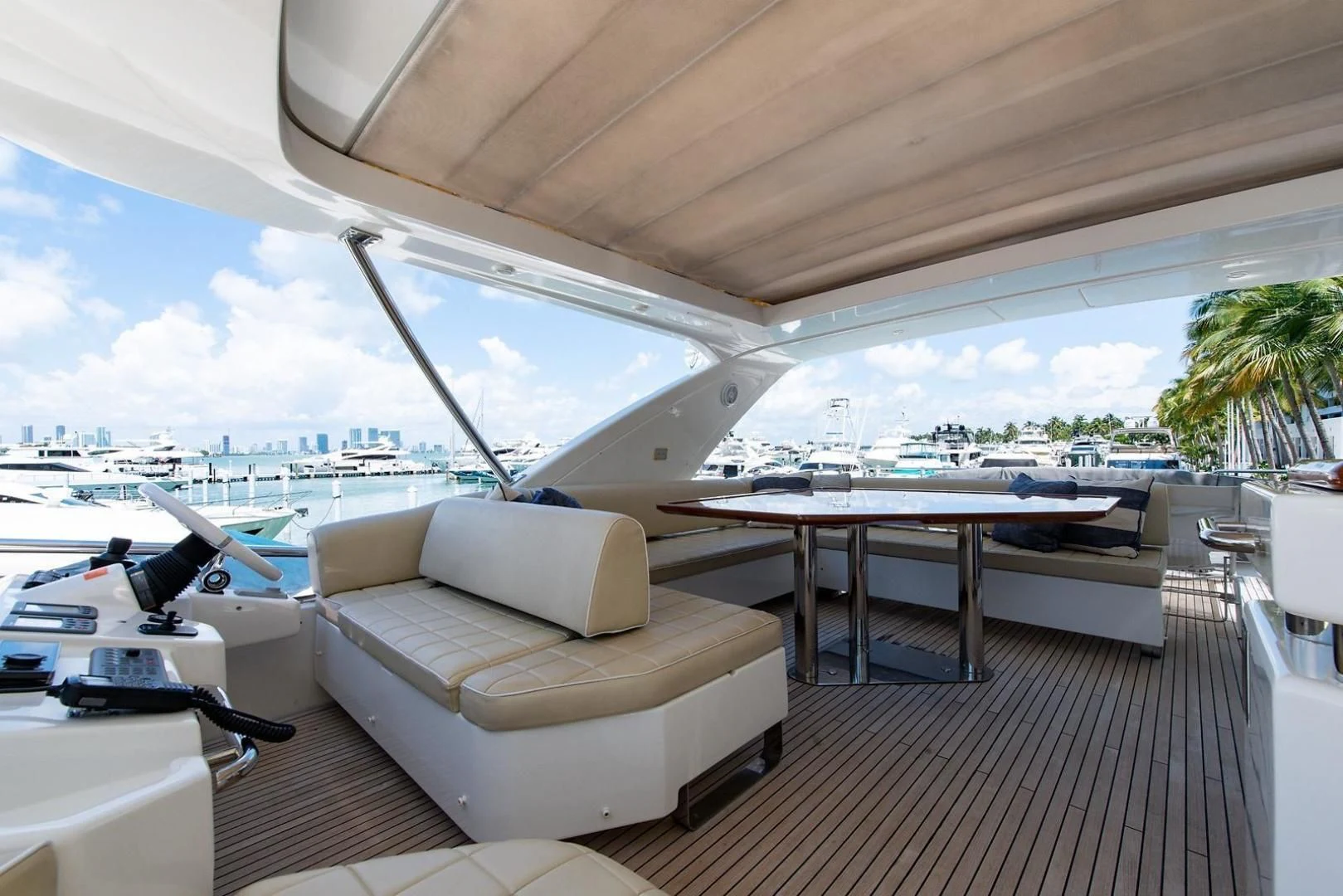 a lounge area with a table and chairs on it aboard SOMEWHERE I BELONG Yacht for Sale