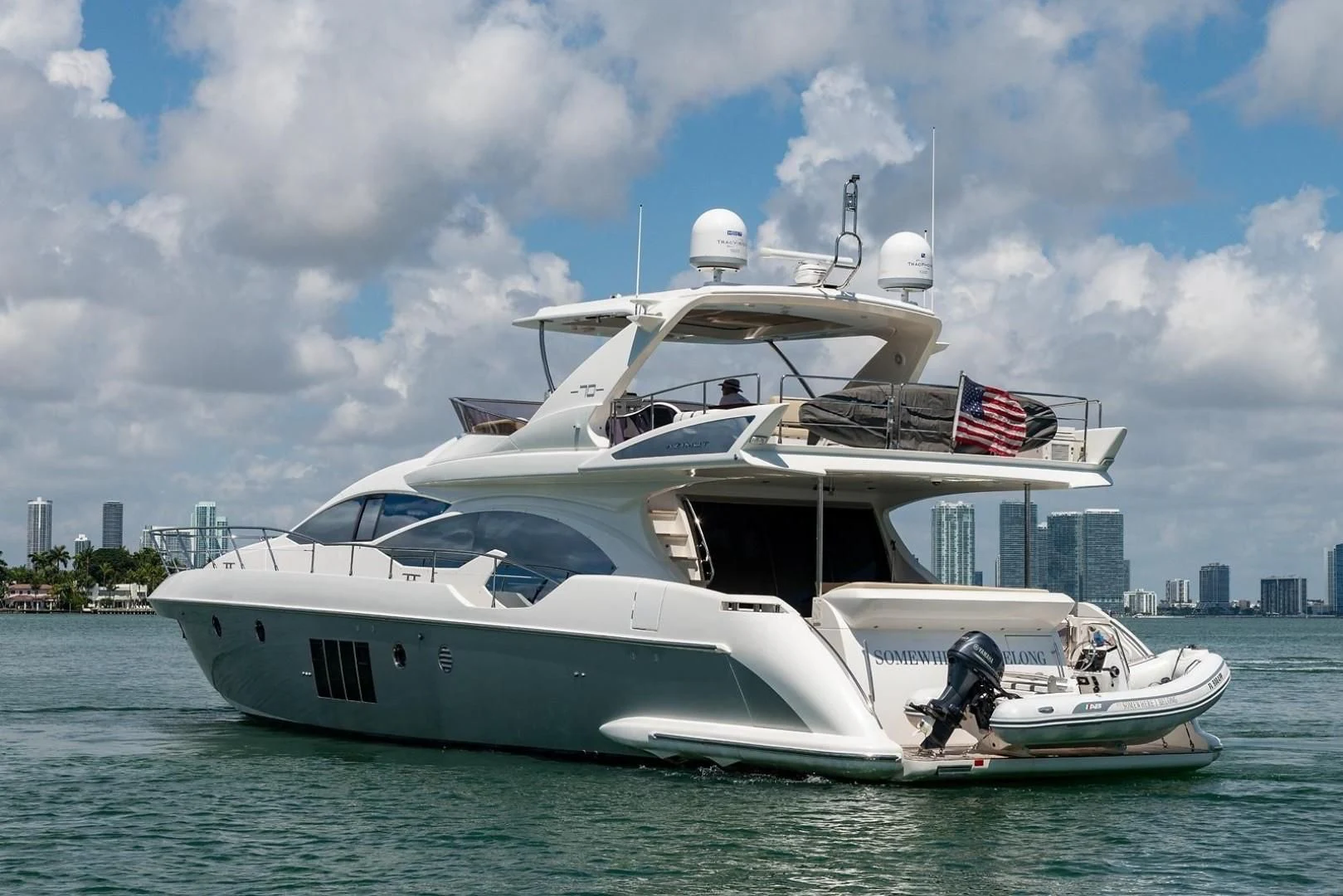 a white yacht on the water aboard SOMEWHERE I BELONG Yacht for Sale