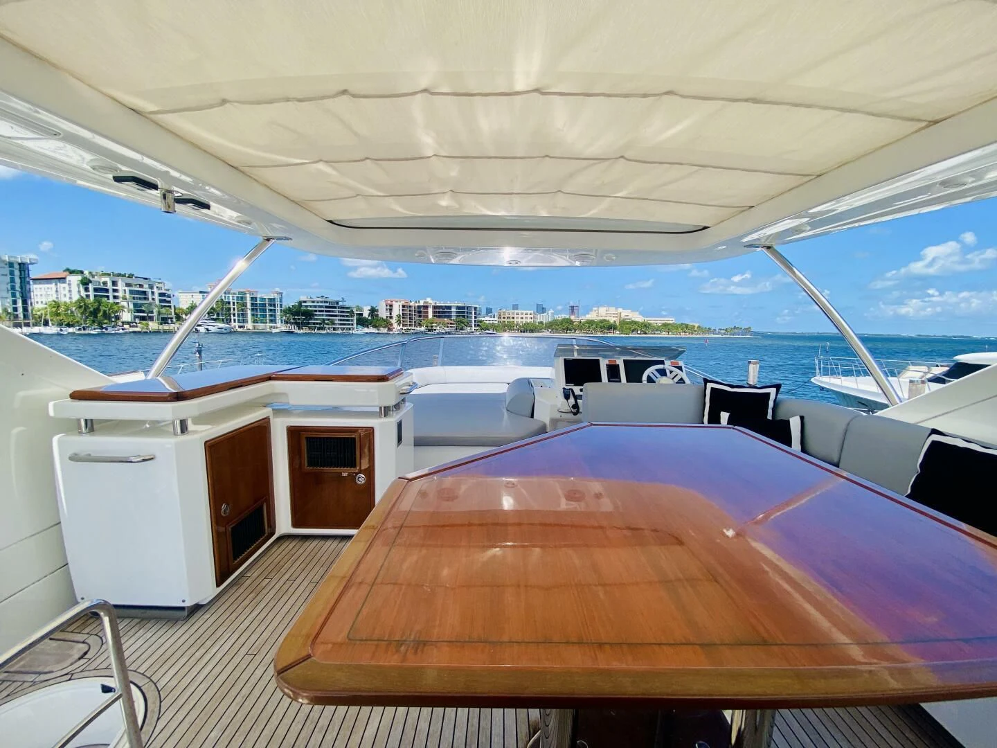 a deck with a table and chairs on it aboard SOMEWHERE I BELONG Yacht for Sale