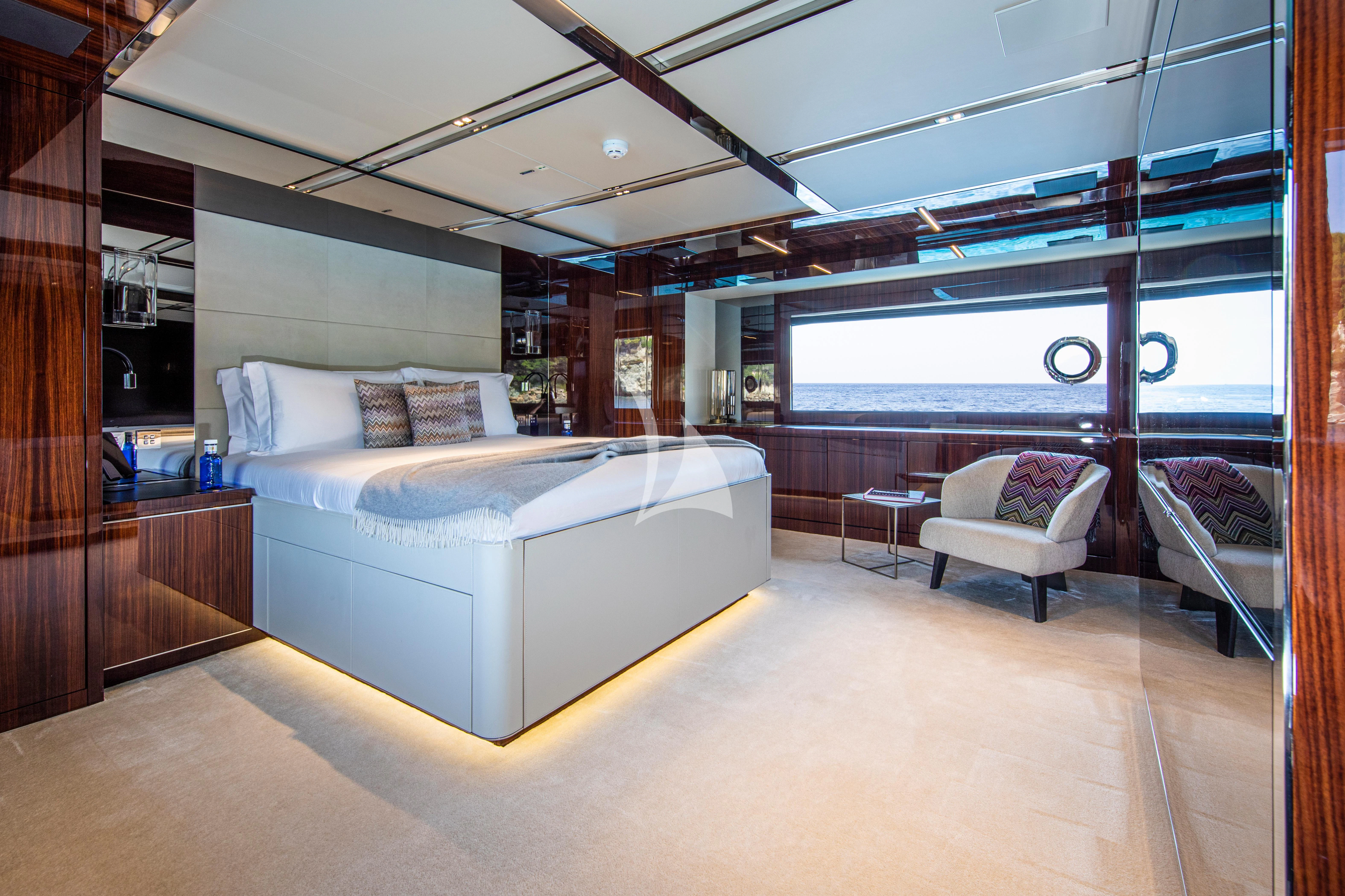 a room with a bed and a chair aboard FIGURATI Yacht for Sale
