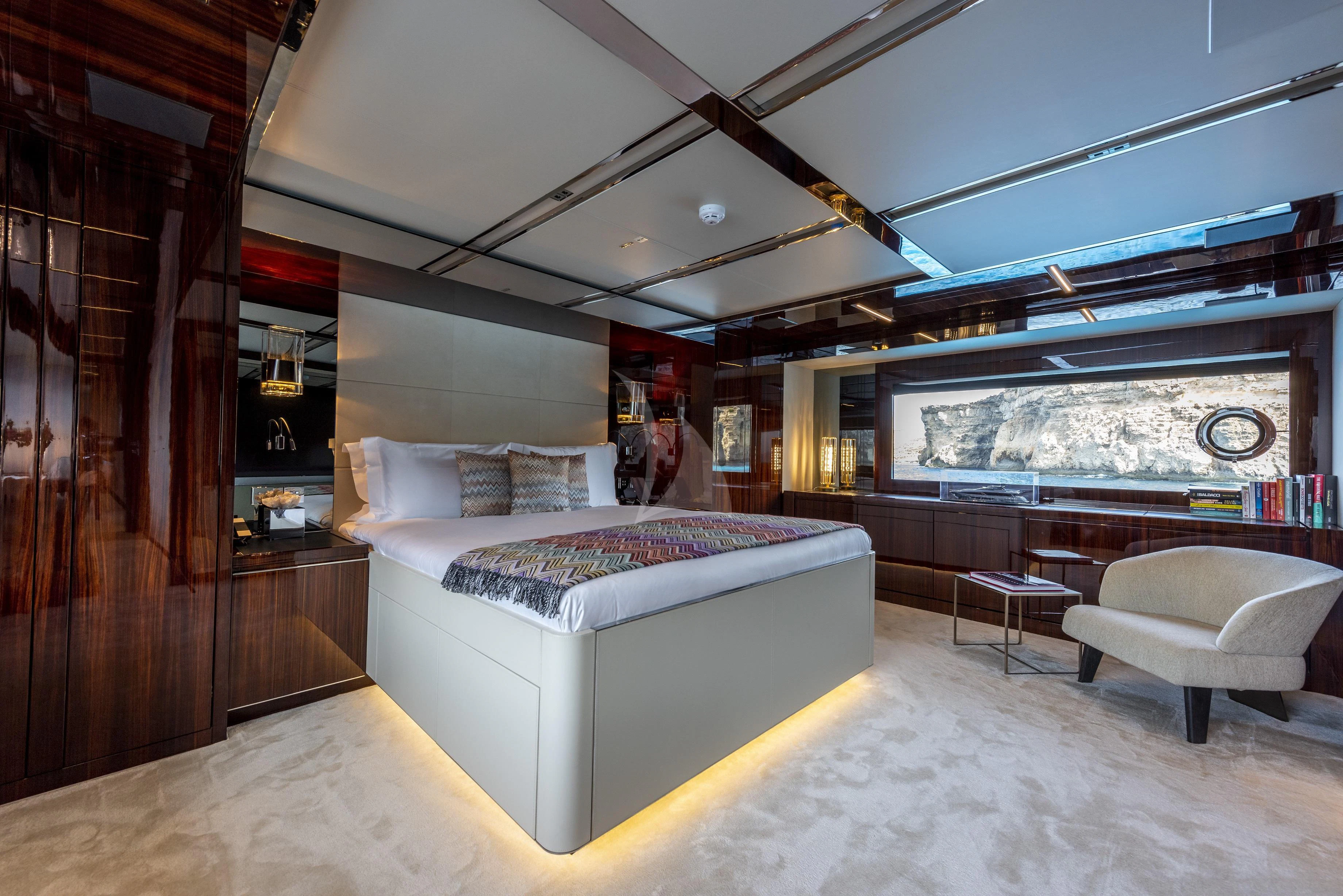 a room with a bed and a large window aboard FIGURATI Yacht for Sale