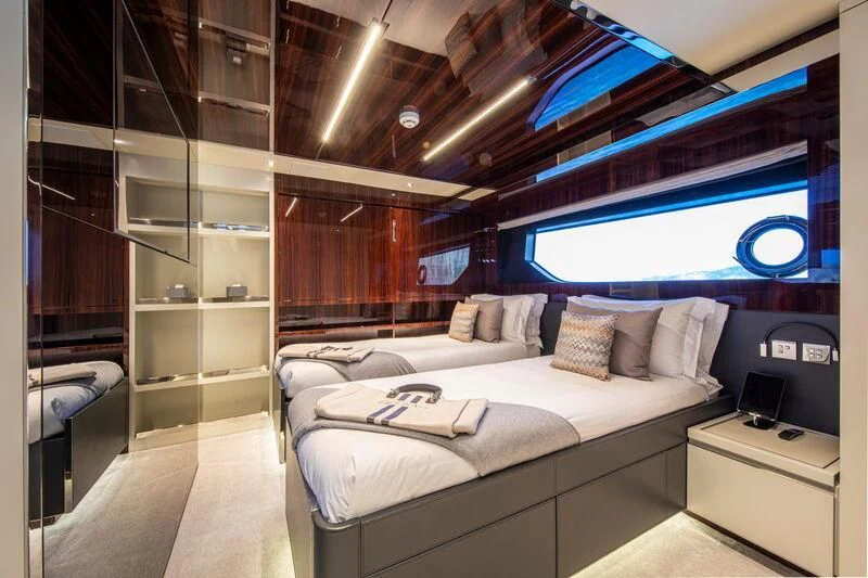a room with a bed and a tv aboard FIGURATI Yacht for Sale