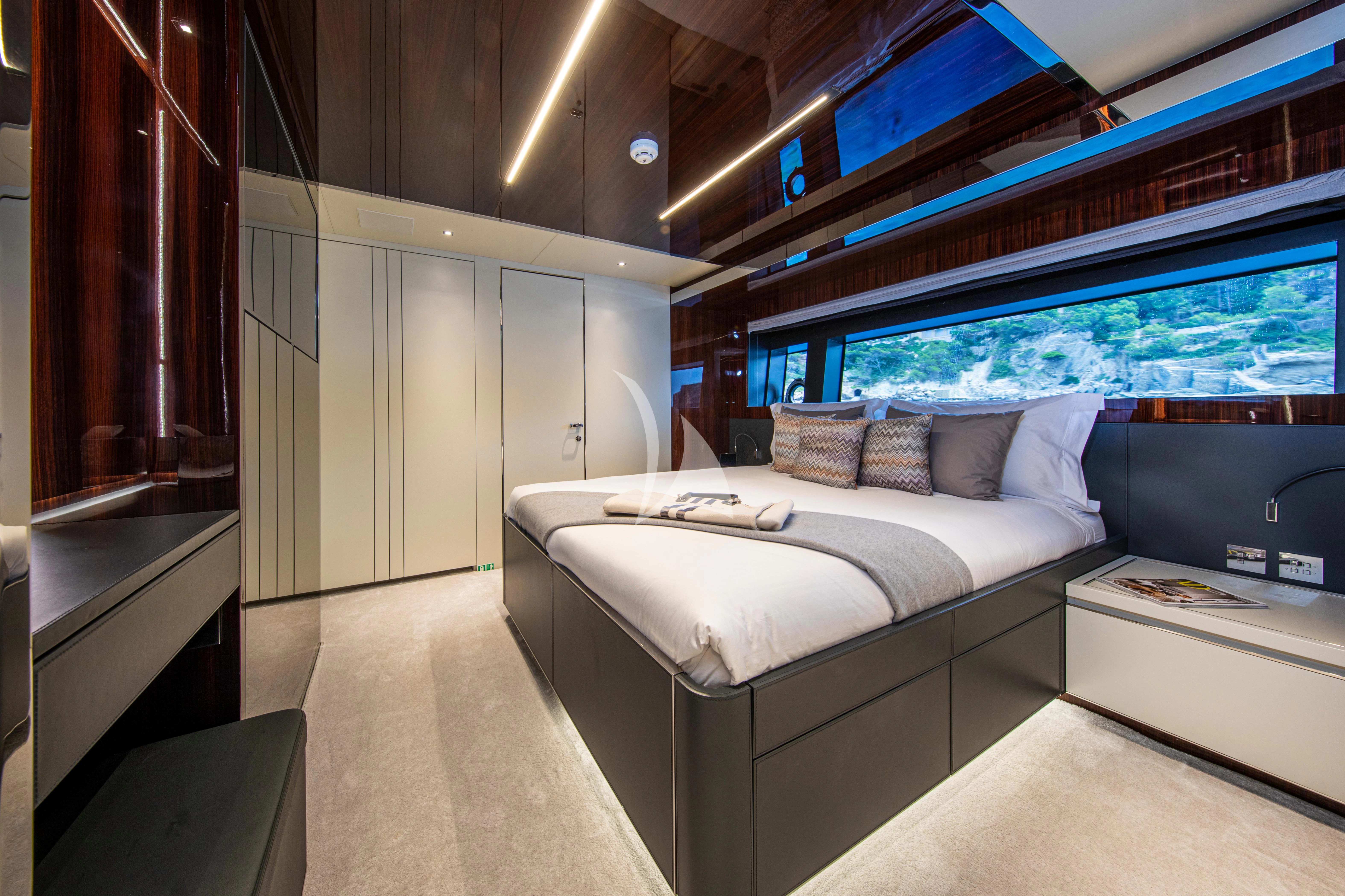 a room with a bed and a window aboard FIGURATI Yacht for Sale