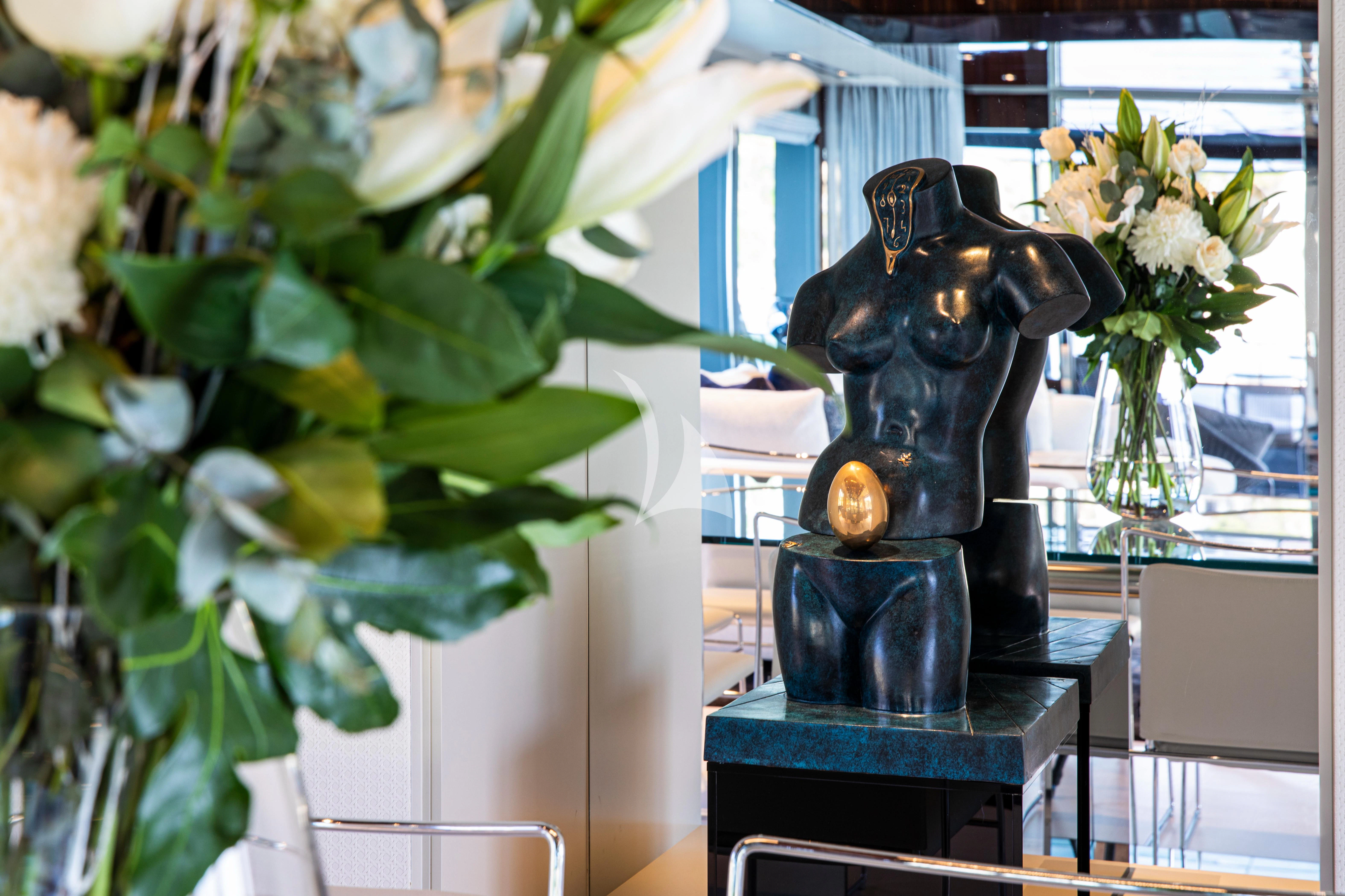 a statue of a dog with flowers aboard FIGURATI Yacht for Sale