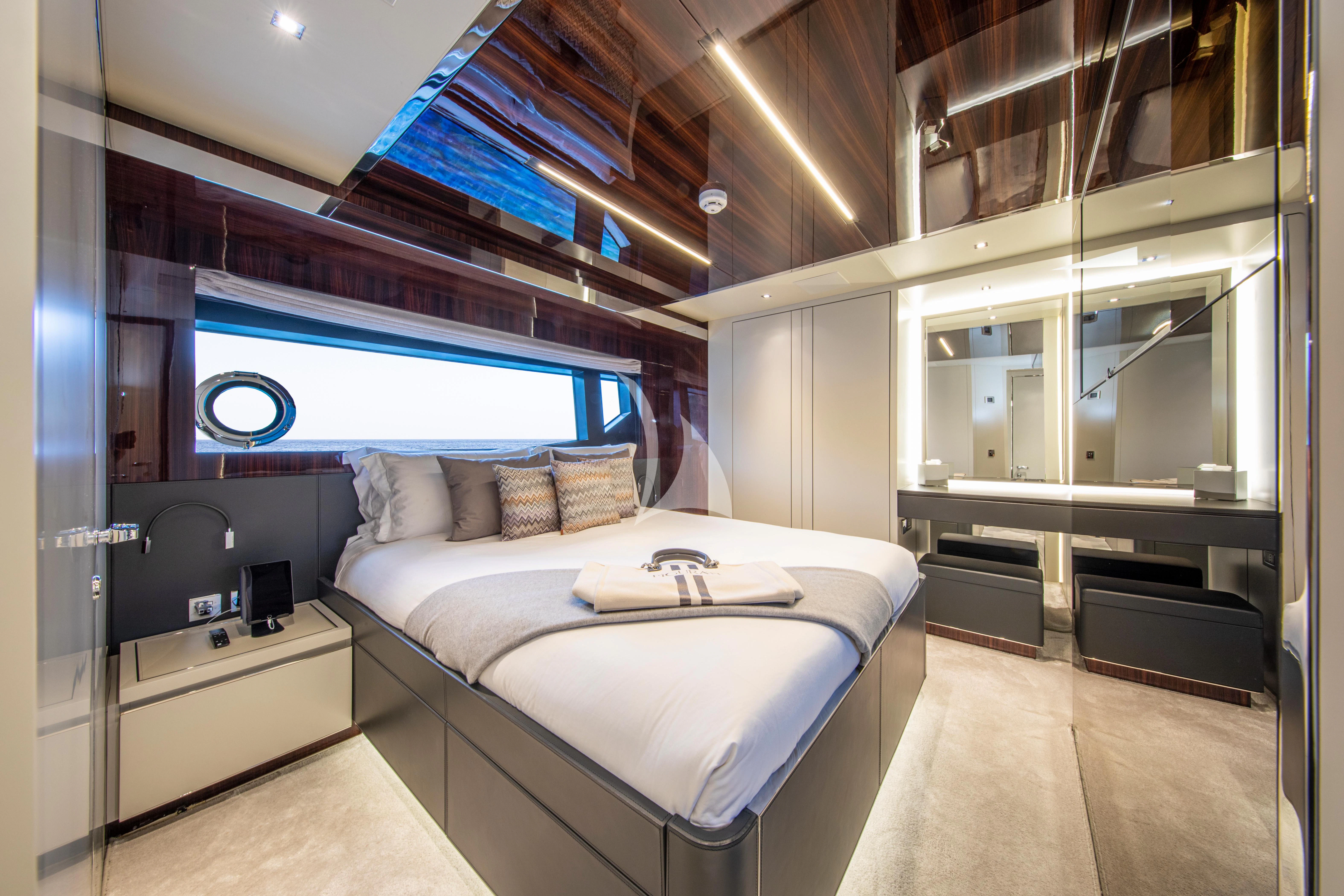 a bedroom with a large bed aboard FIGURATI Yacht for Sale