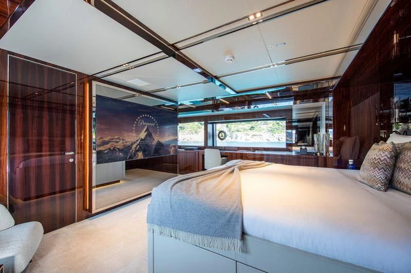 a room with a bed and a painting on the wall aboard FIGURATI Yacht for Sale